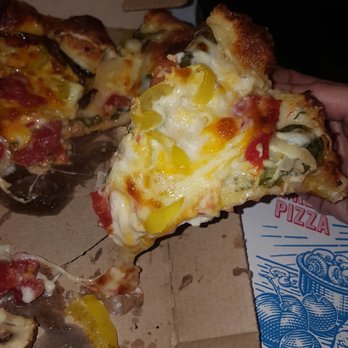 Domino's Pizza - a hand holding a slice of pizza - Pizza Near Me - Tucson, Arizona Domino's Pizza - a hand holding a slice of pizza - Pizza Near Me - Tucson, Arizona