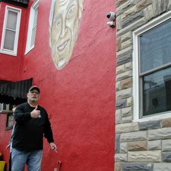 Muir's Tavern - Was walking by Muir's and this guy, I think an owner in the family, asked me to take a picture with the mural. So here.
