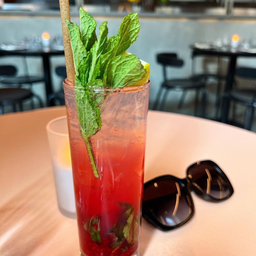 a tall glass with a straw and mint a tall glass with a straw and mint