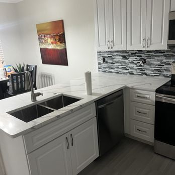 Royal Kitchens and Baths - a clean kitchen with white cabinets and stainless steel appliances - General Contractors Near Me - Vero Beach, Florida Royal Kitchens and Baths - a clean kitchen with white cabinets and stainless steel appliances - General Contractors Near Me - Vero Beach, Florida