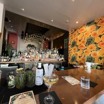 The Miranda - a bar with a bunch of flowers on the wall - Cocktail Bars Near Me - Oakland, California The Miranda - a bar with a bunch of flowers on the wall - Cocktail Bars Near Me - Oakland, California