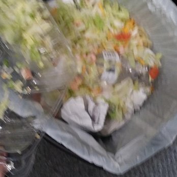 Cajun Potato Kitchen - a person holding a plastic bag of food - Cajun/Creole Near Me - Thibodaux, Louisiana