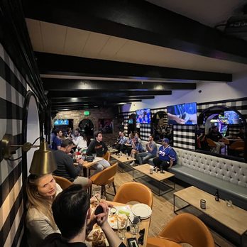 Busby's West - a group of people eating and drinking - Sports Bars Near Me - Santa Monica, California