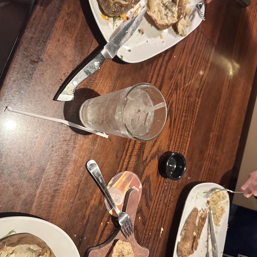 Meat, loaded baked potatoes and salad Meat, loaded baked potatoes and salad
