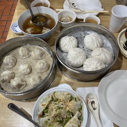 Spicy shrimp dumplings with chives, steamed pork buns, soup dumplings, and Shanghai style wanton soup.