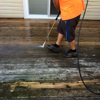 Nice Guys Landscaping - a man using a pressurer on a deck - Tree Services Near Me