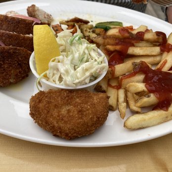 Tides Restaurant - Some lobster-stuffed chicken, a crabcake, french fries, vegetables, coleslaw - Canadian (New) Near Me - Alma, New Brunswick