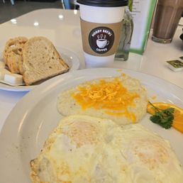 Two egg breakfast with cheese grits and sourdough toast