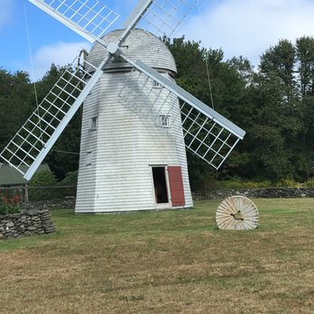 Jamestown Windmill - The windmill and example grindstone in front. - Landmarks & Historical Buildings Near Me - Jamestown, Rhode Island