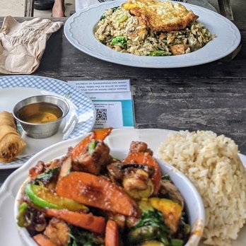 Thai Fresh - Close plate is Pad Prik King, far plate is green curry fried rice, egg rolls in the center. - Thai Near Me - Austin, Texas