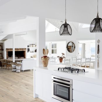 Interiors & Textiles - a white kitchen with wood floors - Flooring Near Me - Campbell, California