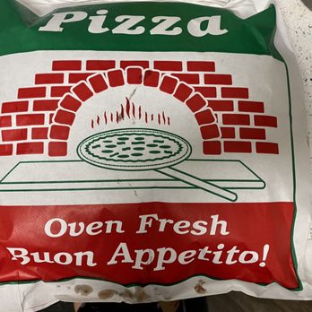 Dan's Pizza - a bag of pizza - A plastic pizza delivery bag displays a graphic of a brick oven with flames and a pizza peel. The bag has green, white, and red colors, resembling the Italian flag. The text 'Pizza' is at the top, and 'Oven Fresh Buon Appetito!' is written at the bottom, indicating fresh pizza and an Italian greeting. The bag is placed on a light-colored surface with some stains visible. - Pizza Near Me - Downers Grove, Illinois