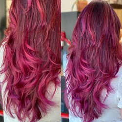 Red and plum highlights in long layered cut.