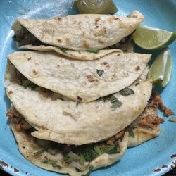 Pacos Bussin Tacos - 3 flour tortilla tacos with lime and sauce.
