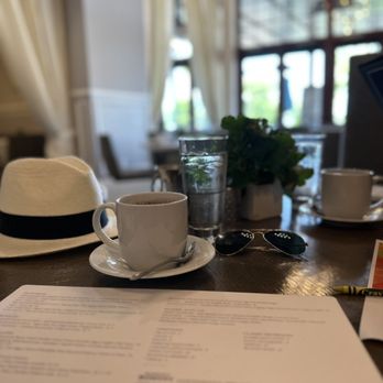 20|Twenty - a hat, a cup of coffee and a menu on a table - New American Near Me - Carlsbad, California 20|Twenty - a hat, a cup of coffee and a menu on a table - New American Near Me - Carlsbad, California