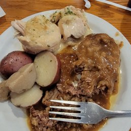 a plate of meat, potatoes, and gravy a plate of meat, potatoes, and gravy