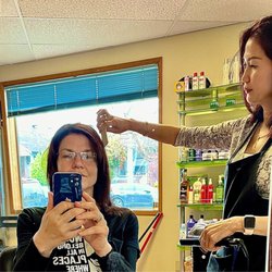 Expo Hair Design - Phuong looks completely in her element. This serious look is the same look when she trims my hair.
