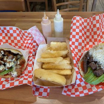 Venezuelan Chamo Cuisine - Cochino Frito (left), Yucca Fritas, Llanera (right) - Venezuelan Near Me - Pasadena, California Venezuelan Chamo Cuisine - Cochino Frito (left), Yucca Fritas, Llanera (right) - Venezuelan Near Me - Pasadena, California
