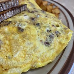 Historic Village Diner - Create Your Own Omelette (Plain): $6.95 / Add Cheddar: $1.95, Add Onions: $1.95, Add Bacon: $2.95