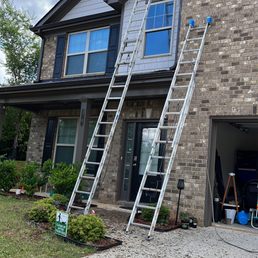 a man on a ladder working on a house