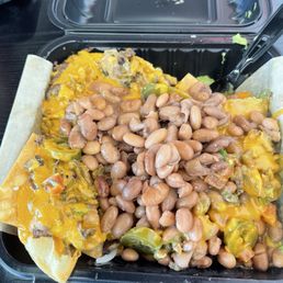 Carne Asada nachos with a nice helping of pinto beans Carne Asada nachos with a nice helping of pinto beans