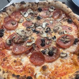 Pepperoni, mushroom and black olive wood fired pizza Pepperoni, mushroom and black olive wood fired pizza