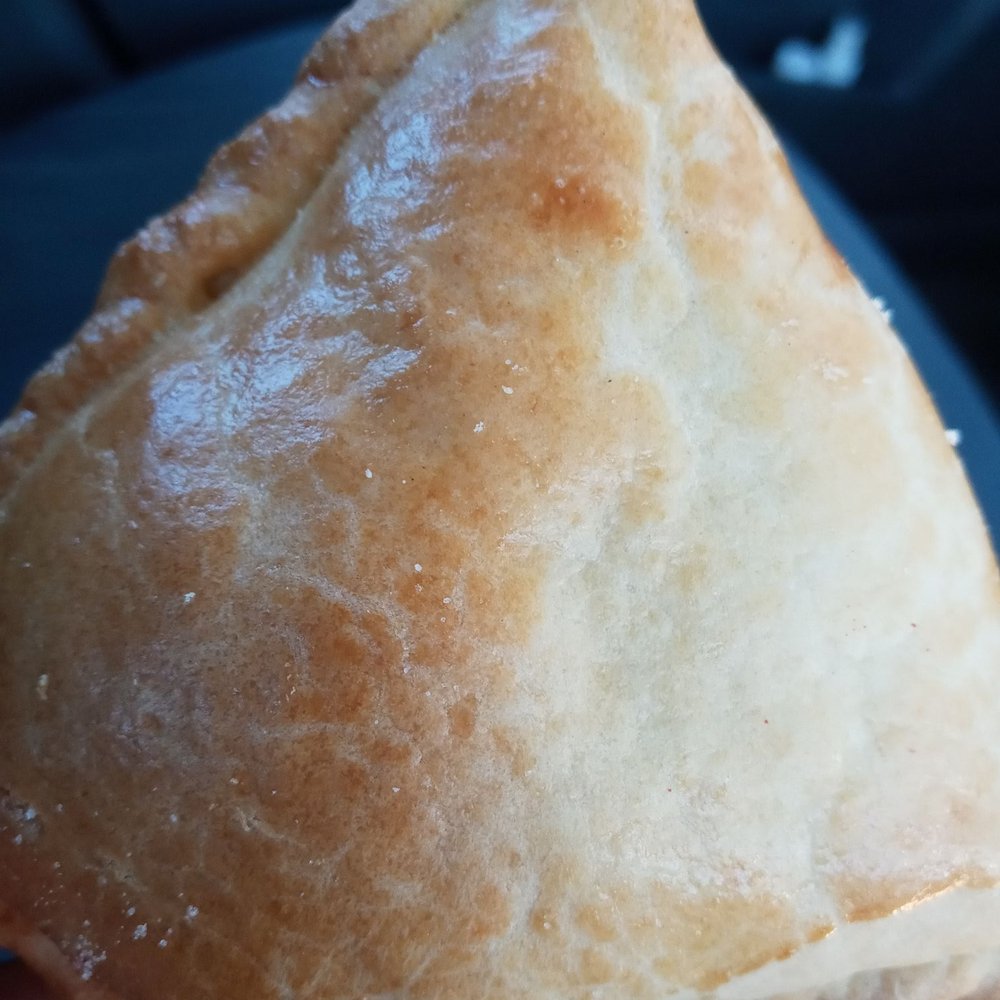 a hand holding a pastry a hand holding a pastry