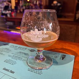 a glass of beer on a table a glass of beer on a table