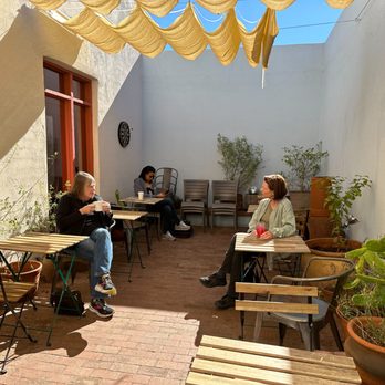 Exo Roast - two women sitting at outdoor tables - Coffee Roasteries Near Me - Tucson, Arizona