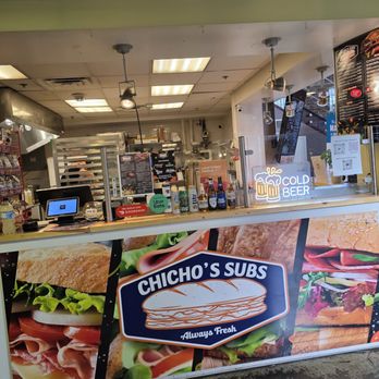 Chicho’s Subs - The ordering counter of Chicho's Subs with colorful posters of photographs of their menu items. - Sandwiches Near Me - Roanoke, Virginia