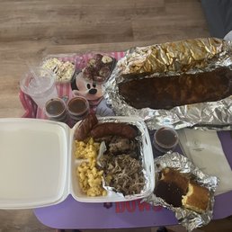 Rack of ribs, sausage, brisket, pulled pork, cole slaw, Mac and cheese, potato salad. Rack of ribs, sausage, brisket, pulled pork, cole slaw, Mac and cheese, potato salad.