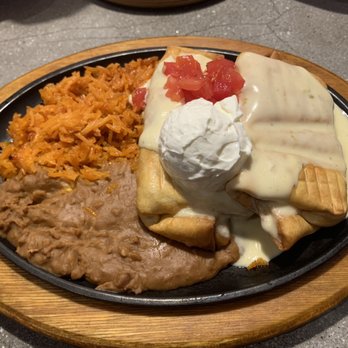 Memo’s Mexican Kitchen - Grilled chicken chimichangas, topped w/ house made queso - Mexican Near Me - Mount Juliet, Tennessee