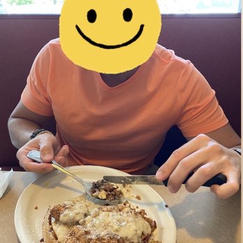 Kristof's Kafe - Boyfriend devouring his concoction - chicken & waffles with two sunny side up eggs & sausage gravy! - American Near Me - Davie, Florida