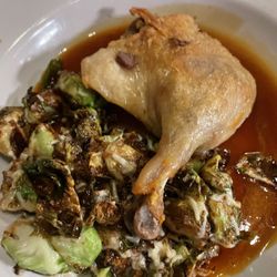 French Rotisserie Café - Confit de Canard (Duck leg) with Brussels Sprouts, gratin dauphinoise, and Dijon sauce.