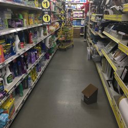 Dollar General - Product on floor, empty box on floor, shopping card with product in isle. Huge box at the end of the isle preventing passage or egress.