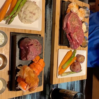 Hot Rocks - Our food served to us. I had filet & lobster, my husband the ribeye. - New American Near Me - Wisconsin Dells, Wisconsin Hot Rocks - Our food served to us. I had filet & lobster, my husband the ribeye. - New American Near Me - Wisconsin Dells, Wisconsin
