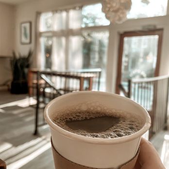 Second State Coffee - a person holding a cup of coffee - Coffee & Tea Near Me - Charleston, South Carolina