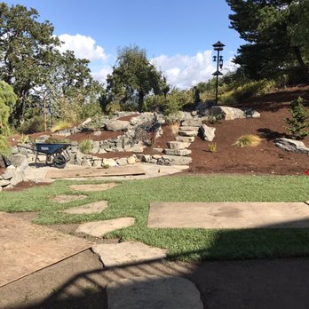 Davidson's Landscape Services - a garden with a stone wall and a bench - Landscaping Near Me - Salem, Oregon Davidson's Landscape Services - a garden with a stone wall and a bench - Landscaping Near Me - Salem, Oregon