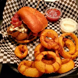 a basket of onion rings and a sandwich a basket of onion rings and a sandwich