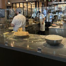 They toss the dough right in the front They toss the dough right in the front