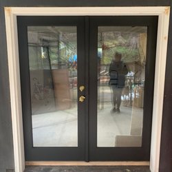 Gap is covered by a 2x4 and shows the height discrepancy between the doors and frame.