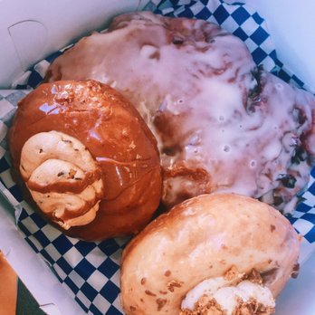 DG Doughnuts - The football sized one is the fritter. Bottom left is the peanut butter crack and the top left is the cookie dough. - Bakeries Near Me - Ocoee, Florida