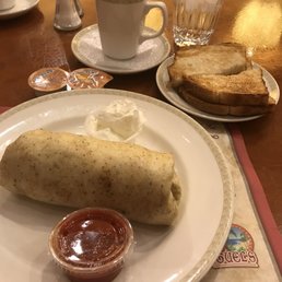 Breakfast Burrito on wheat tortilla with scrambled egg, bacon and cheese inside. Breakfast Burrito on wheat tortilla with scrambled egg, bacon and cheese inside.