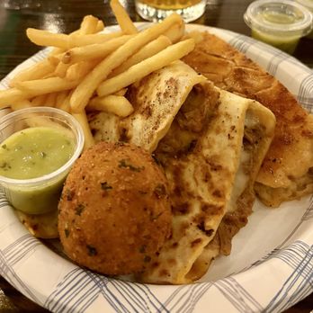 Smokin Cubana Cuisine - Close up of their potato ball, ropa vieja quesadilla, half of a Cuban sandwich, fries and yummy green sauce! - Cuban Near Me - upland, California Smokin Cubana Cuisine - Close up of their potato ball, ropa vieja quesadilla, half of a Cuban sandwich, fries and yummy green sauce! - Cuban Near Me - upland, California