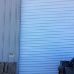 16'x16' White Amarr 5651 Non-Insulated Heavy-Duty Wind Load Rolling Sheet Door with Reduced Drive Chain Hoist.