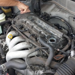 KT's Auto Repair - Checking for leaks on a valve cover.