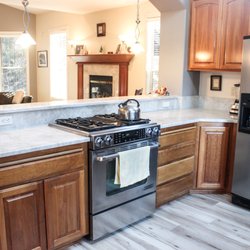 New River Homes - Kitchen remodel. Counters match the fireplace surround in the background.