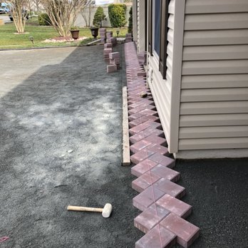 NUNEZLandscaping - a brick walkway being laid in front of a house - Masonry/Concrete Near Me - Asbury Park, New Jersey NUNEZLandscaping - a brick walkway being laid in front of a house - Masonry/Concrete Near Me - Asbury Park, New Jersey