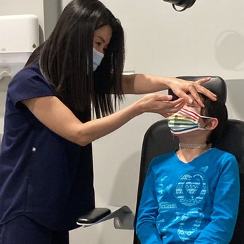 2 See Optometry - Dr. Han is placing her ortho K contacts in her eyes to get them checked. - Optometrists Near Me - Glendale, California