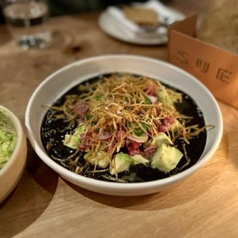 Suerte - Aguachile de Ribeye had burnt habanero salsa as the base for Wagyu ribeye, avocado, red onion, serrano peppers, and potato sticks. - Mexican Near Me - Austin, Texas
